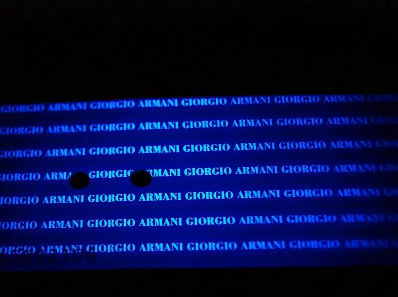 Armani certificate under UV light.