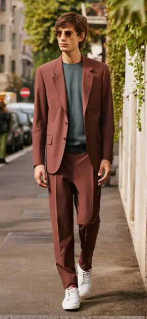A man wearing a CC collection suit. 