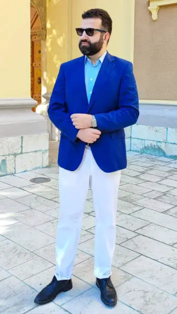 Leon Papo wearing a Tommy Hilfiger navy blazer with white Canali pants.  